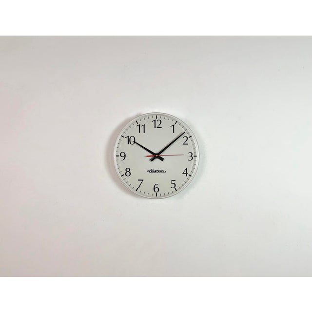 Industrial wall clock was produced by Elektročas in Czech republic during the 1990s. It features a white plastic dial and...