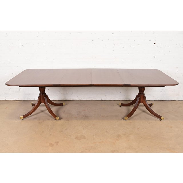 An exceptional Georgian or Regency style double pedestal extension dining table By Baker Furniture, "Historic Charleston"...