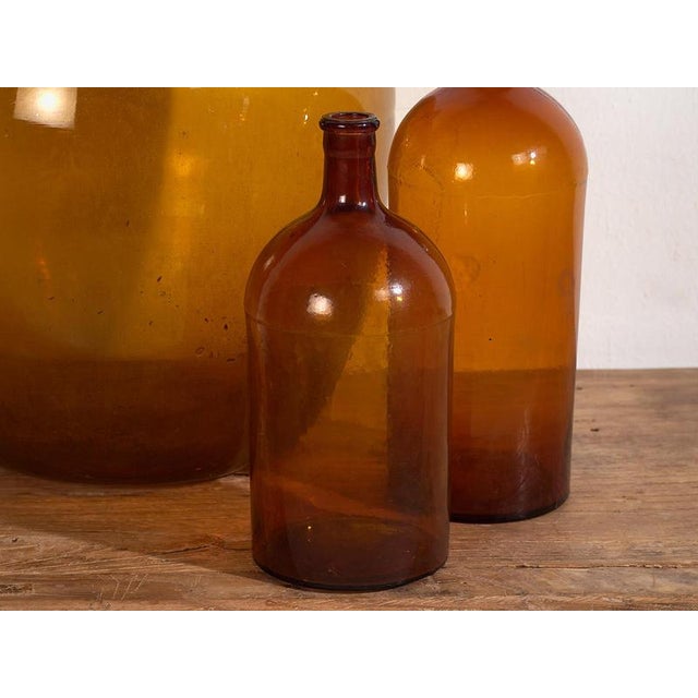 Antique amber bottles (c.1920) Style: French Provincial Materials and techniques: Glass Place of origin: France Epoch:...