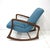 A walnut toned sculptural wood framed rocking chair reupholstered in a nice tightly woven blue Knoll contract fabric....