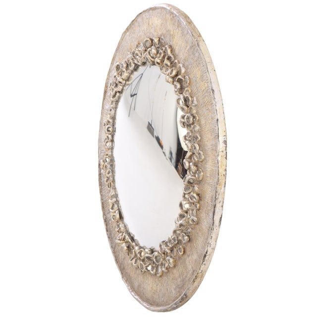 The frame is composed of silvered antique glass elements embedded within a richly textured surround, recalling the poetic...