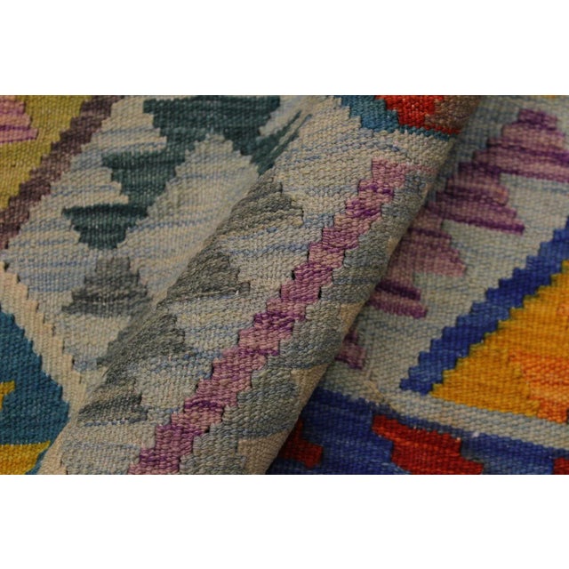 "Add a touch of elegance to your home with this casual chic hand woven Tribal Kilim wool rug. Constructed on a loom by...