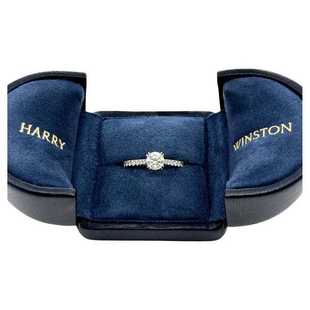 Elevate your jewelry collection with this exceptional Harry Winston diamond ring, featuring a stunning 0.75 carat round...