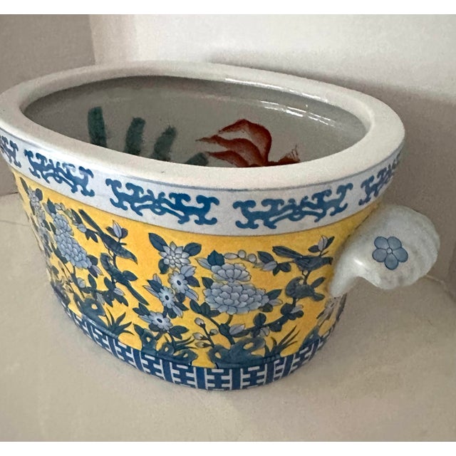 Cheerful yellow and blue chinoiserie fish bowl planter with floral and bird motif. Hand painted koi fish on interior....