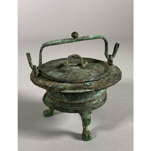 Bronze Vessel, Ancient Roman Period, 1st-2nd Century AD. Ritual vessel used for cooking sacrificial offerings. Rests on a...