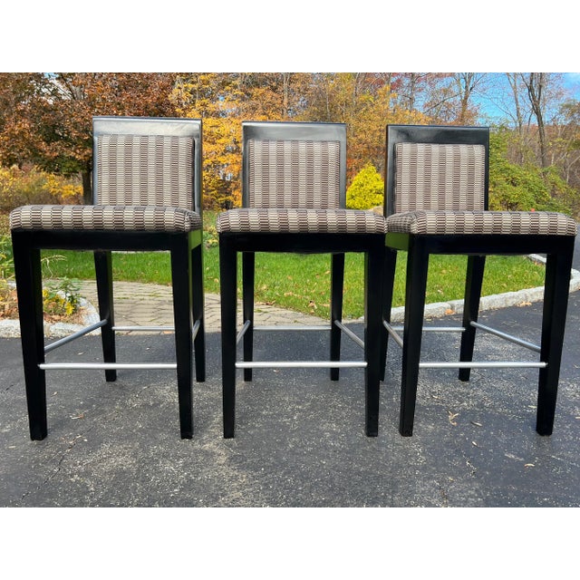 A trio of 2000's Holly Hunt attributed mahogany upholstered bar or counter stools. Thick, sturdy mahogany frame with an...