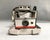 A 1960s Polaroid Land Camera - #220. The vintage camera has folding bellows, a plastic body, two lenses and two windows. A...