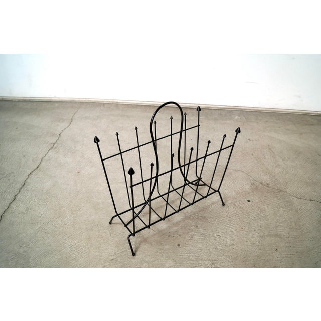 Vintage original Midcentury Modern magazine rack for sale. Can also be used to hold records. It's made of iron with a...