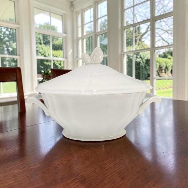 This Limoges scalloped covered tureen is a substantial mid-20th-century French porcelain serving piece with a rounded...