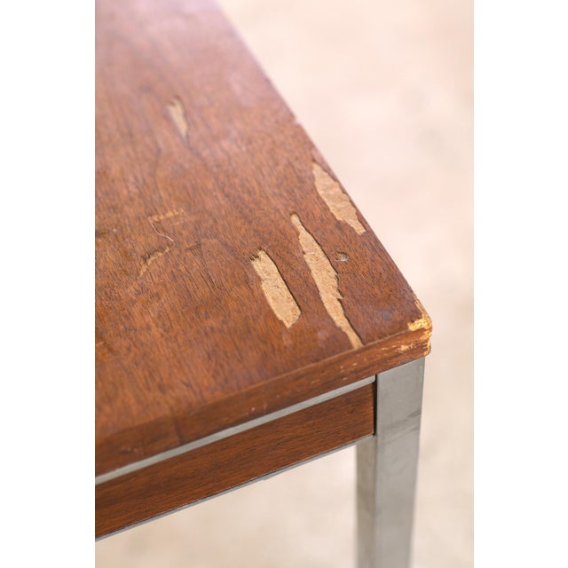 Mid Century Modern mahogany veneer table leaning into the Minimalist aesthetic. Steel chrome legs and chrome trim contrast...
