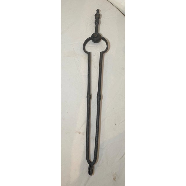 Up for sale is a pair of rare antique 18th century wrought iron and brass English fireplace tongs. The arms are wrought by...