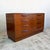 Two banks of four full-width drawers, each fitted with the sculpted solid teak handles characteristic of the Fresco range....