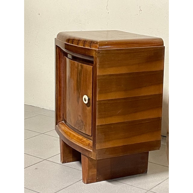 A pair of Art Deco bedside tables from the 1930s, made in Italy. The frame is made of fine walnut burl, enriched with...