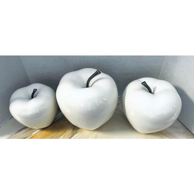 From the Ethan Allen Accents collection, are 3 beautiful white glazed ceramic apples in graduated sizes. Stems are chrome....