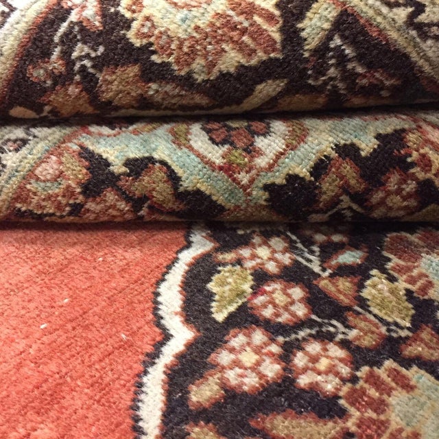Antique handwoven Tabriz rug featuring a central medallion on a terracotta field. Minor age wear, low pile.