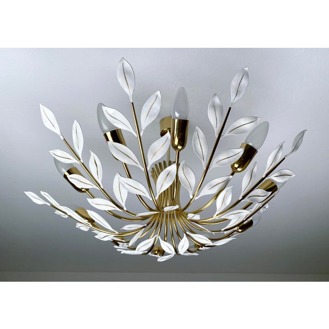 Large mid century pendant light featuring 10 brass curved spokes adorned with white leaves and handpainted gold highlight...