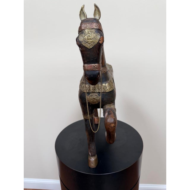 Large mid-century carved fruitwood horse sculpture with applied brass and copper-toned metalwork, retaining a “Made in...