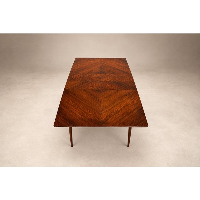 A sculptural Brazilian Modern extendable dining table crafted from richly figured caviúna hardwood in the 1960s. Its...