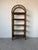 Beautiful 1970's vintage coastal etagere featuring a striking arched bamboo and rattan frame with five wood display...