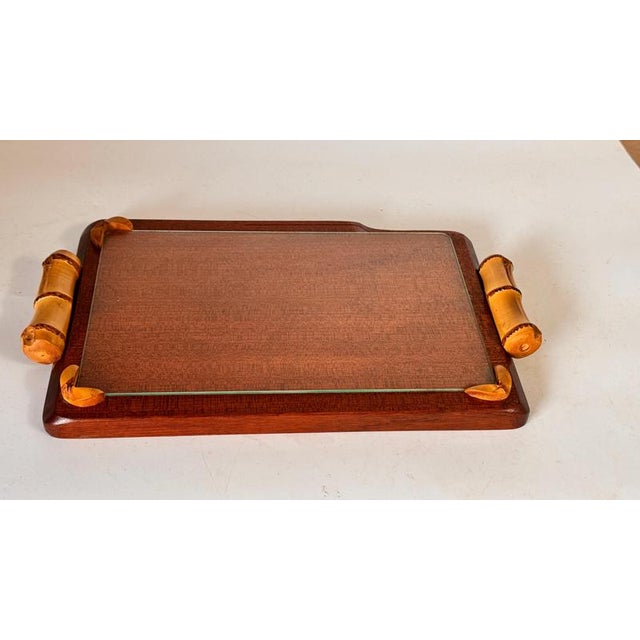 This elegant cheese tray was crafted in France in the 1970s. It combines a solid wooden base with a removable glass plate,...