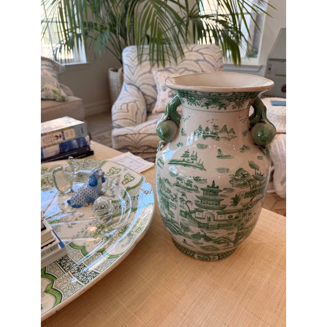 A charming pair of porcelain decorative vases in the loveliest shade of green, these whimsical pieces are full of...