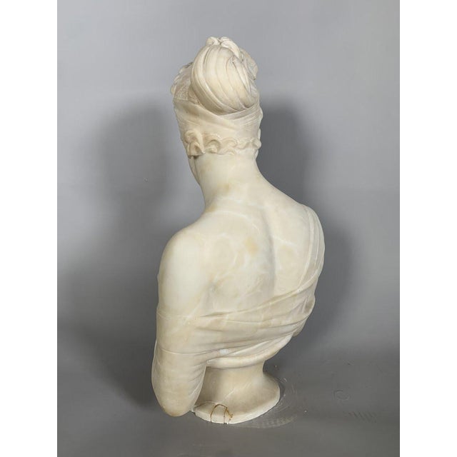 A white marble sculpture depicting a bust of Madame de Récamier after Joseph Chinard (1756-1813). Made of fine, heavy...