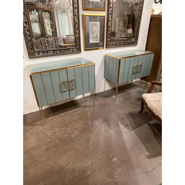 Fabulous pair of murano glass and brass side cabinets in a pale green. Nice brass details and a shelf inside for storage....