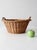 This vintage oval wicker basket features a deep woven body, warm brown finish, and distinctive twisted handles at either...