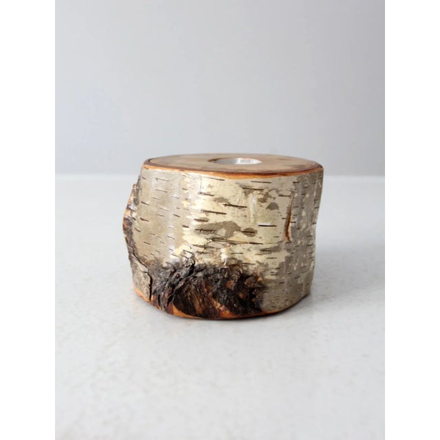 Hand-crafted from a birch tree log, this vintage tea light candle holder brings a rustic, natural feel to any room.