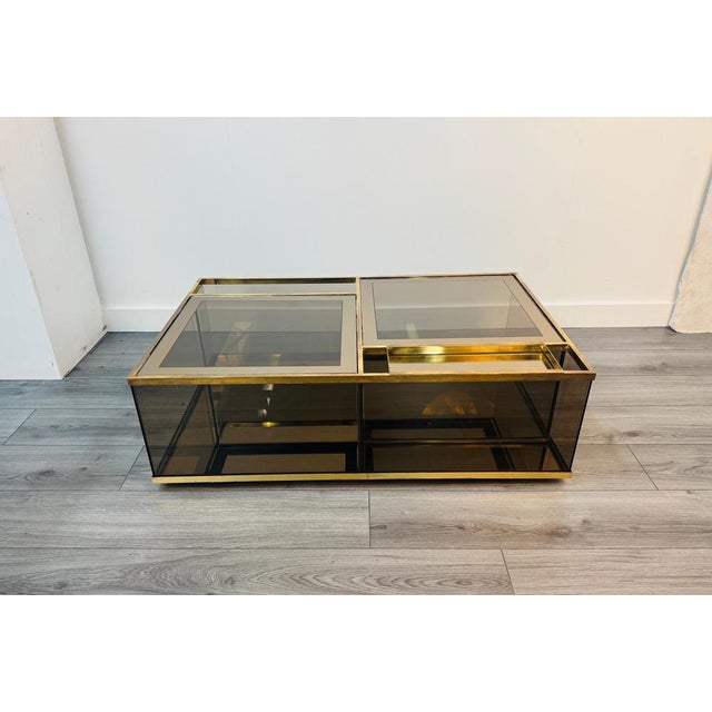 A fabulous cocktail coffee table with multiple functions. The top glass sections can be opened to reveal two separate...
