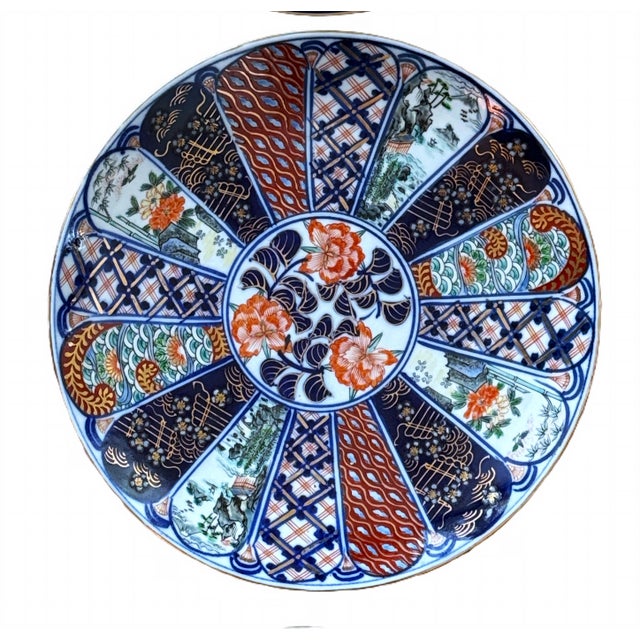 Antique, Imari scalloped plate beautifully executed with flowers and alternating panels of hand painted designs. Japan,...