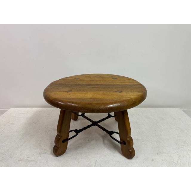A solid oak coffee table dating from the 1960s, combining rustic weight with a distinctly sculptural presence. The table...