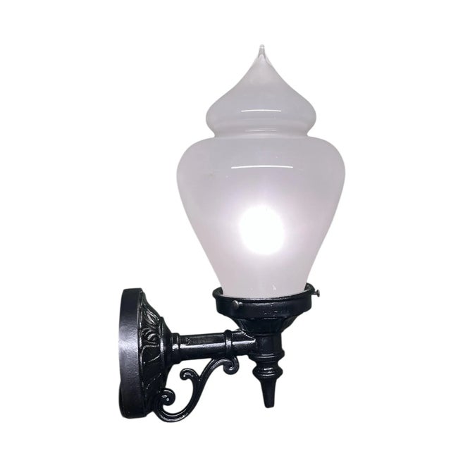 Nice outdoor light made from cast iron with new black paint. Unusual shade shape looks like an ice cream. Screws to wall....