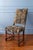 This 17th-century French Louis XIII walnut side chair features a finely turned frame with elaborate barley-twist legs and...