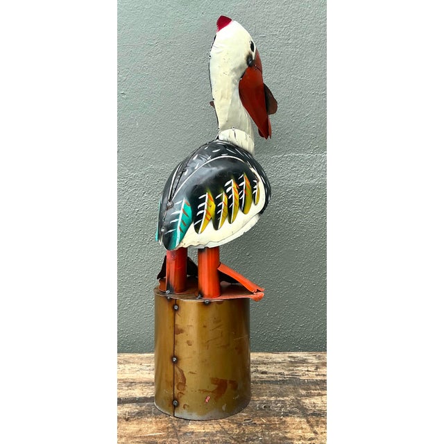 This whimsical vintage pelican sculpture is a captivating example of coastal folk art, expertly crafted using industrial...