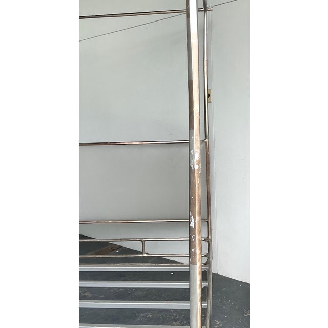 This vintage king canopy bed frame is a striking example of industrial modernism, featuring an architectural metal...