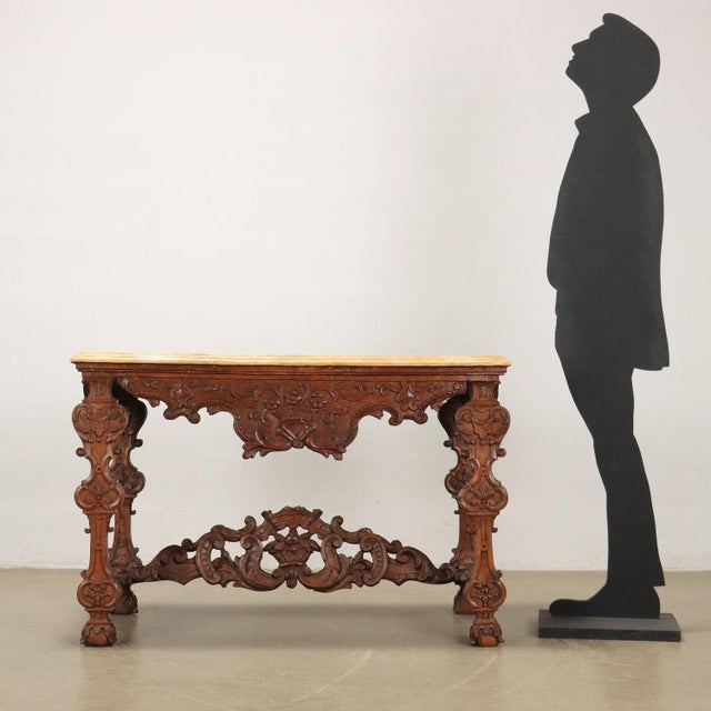 Baroque console in lime wood, Lombardy, early 18th century. Marbled molded top, under-top band and shaped uprights,...