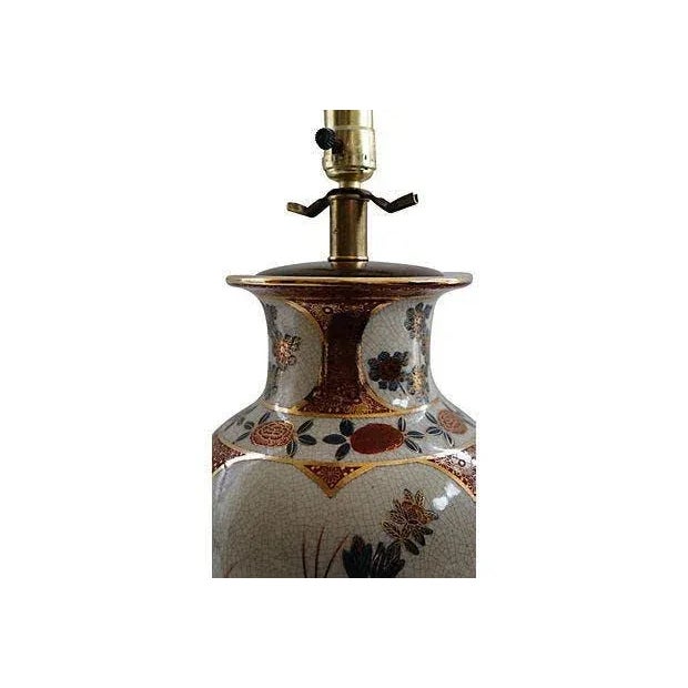 Large vintage hand-painted Imari-style floral table lamp. The ginger jar-shaped body has three panels with a crazed glaze...