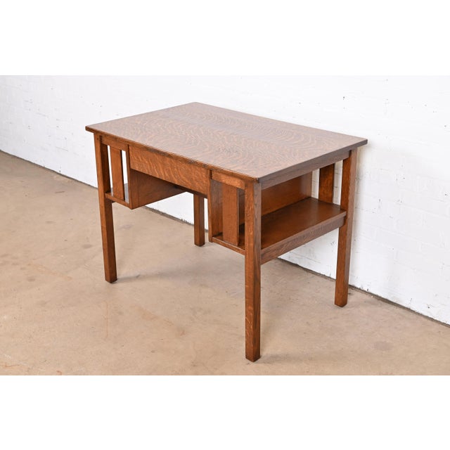 An exceptional antique Mission or Arts & Crafts quarter sawn oak writing desk, library table, or center table. By L. &...