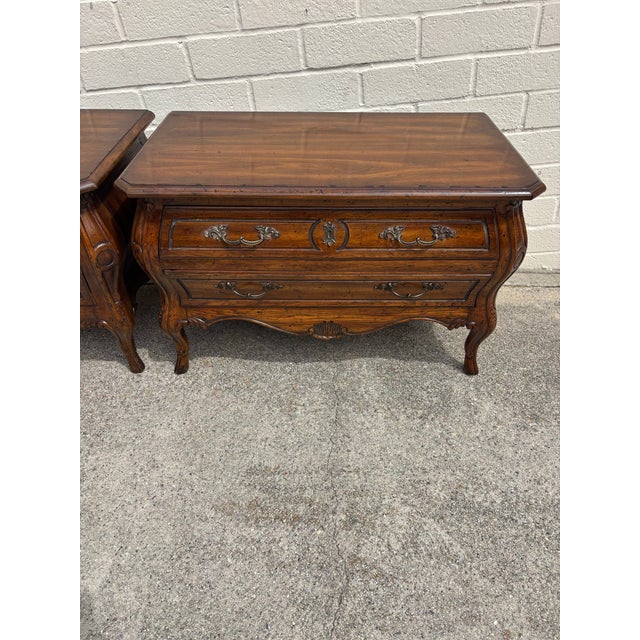 Pair of vintage Heritage Grand Tour French Louis XV style bombe chests / nightstands. Crafted from walnut and features a...