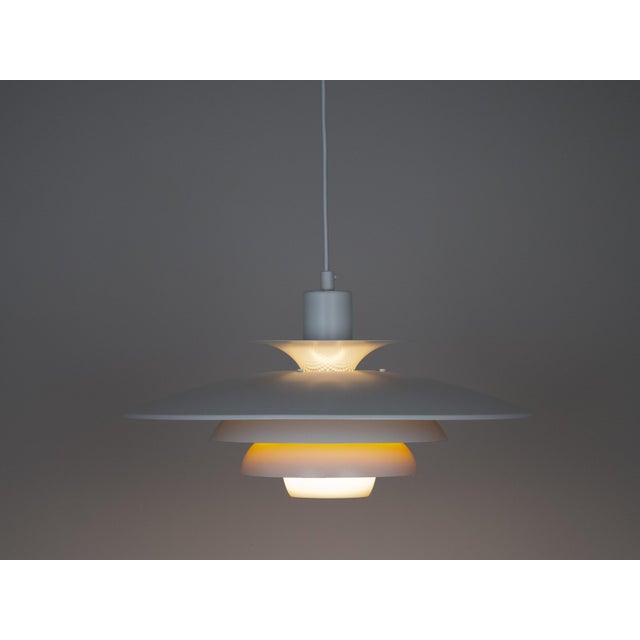 This lamp was designed by Danish designer Kurt Wiborg and manufactured by Jeka. The lamp's form is based on the principle...