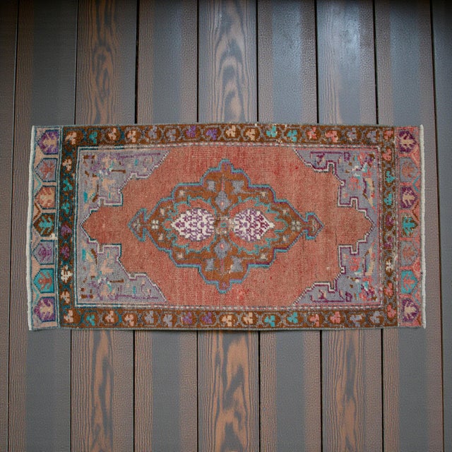 This charming hand-knotted small rug originates from the Chal region of Denizli, featuring a beautifully sun-faded...