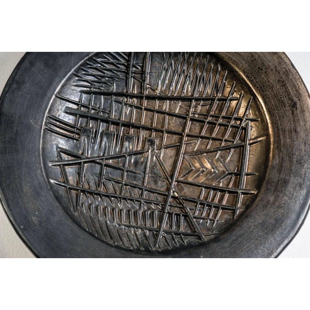 This sculptural wall plate in ceramic was designed by the Italian artist Arnaldo Pomodoro. This piece has an attribution...