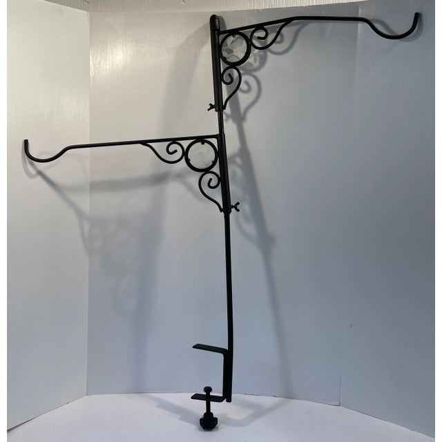 This black iron hanging basket or bird feeder holder clamps on to a railing or table. It also has two round glass etched...