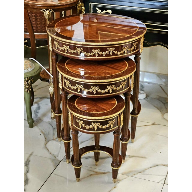 Bring timeless elegance and versatility to your home with this exquisite Set of Three French Nesting Side Tables....