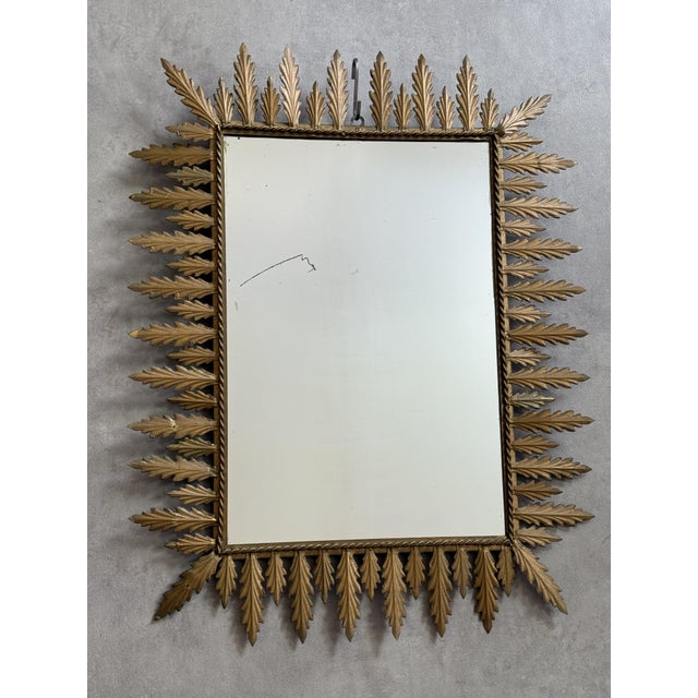 Magnificent rectangular sunburst mirror in wrought iron from the 50s. Italian handcrafted, decorated with leaves.