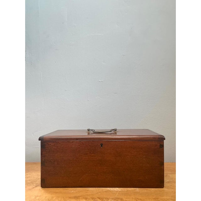 This vintage keyhole wooden box is a beautifully understated example of mid-20th-century craftsmanship, defined by its...
