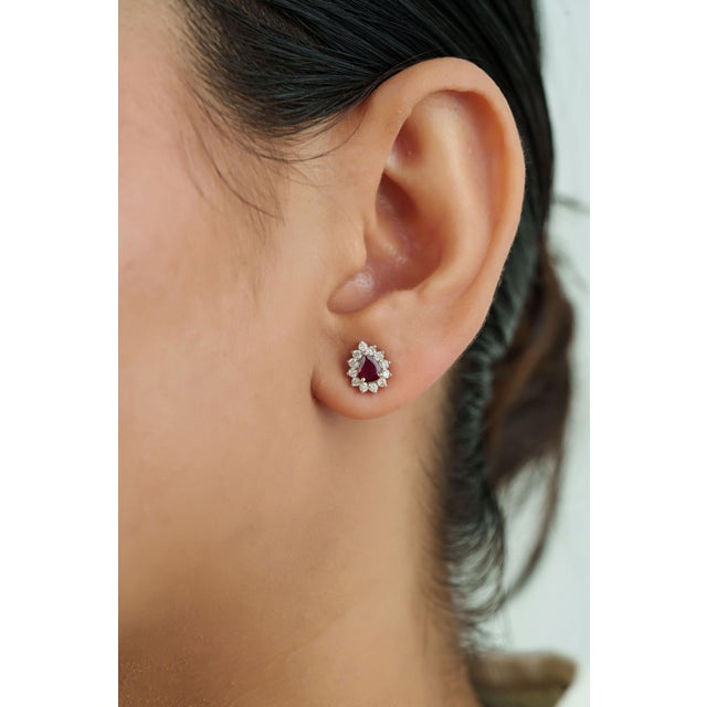 These handmade stud earrings feature 0.66 carats of natural rubies, set in 18K white gold. Each ruby measuring...