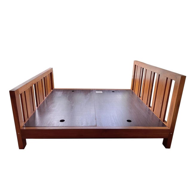 A solid teak bed frame from Singapore. It is made from massive solid pieces of Indonesian teak. dimensions are 72" width x...