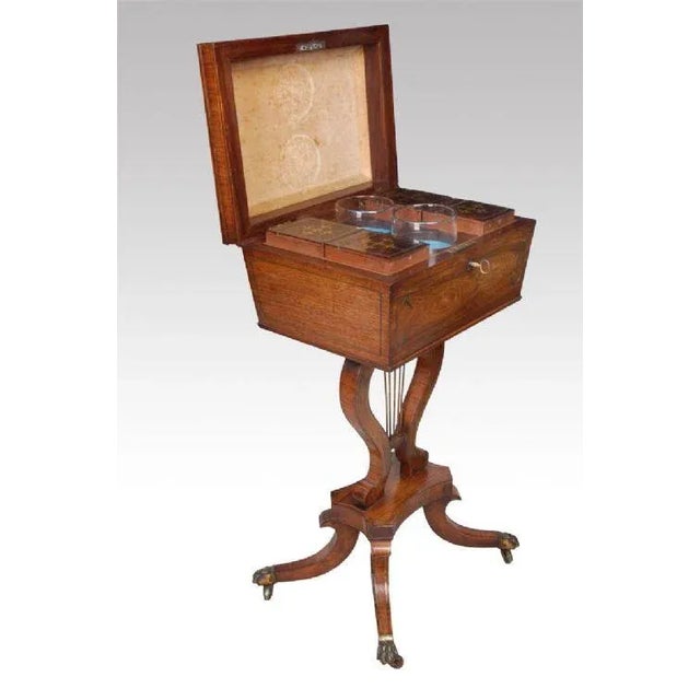 Rosewood brass inlaid teapoy, the top of sarcophagus form with central scroll decorated panel within line borders to lid,...